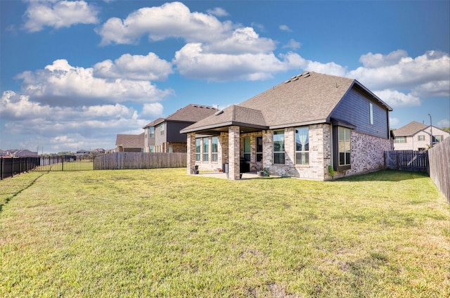 rear view of property with a lawn and a patio area