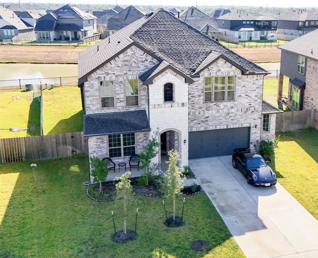 view of front facade with a garage and a front lawn