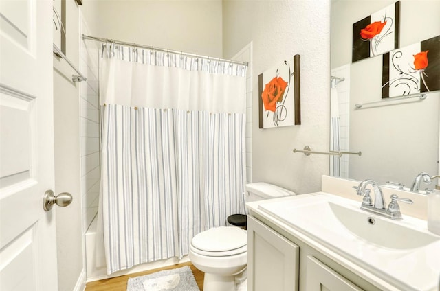 full bathroom featuring vanity, hardwood / wood-style floors, shower / bathtub combination with curtain, and toilet