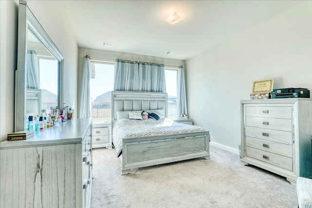 bedroom featuring light carpet