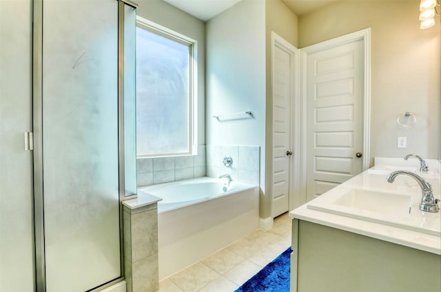 bathroom with vanity, tile patterned flooring, and plus walk in shower