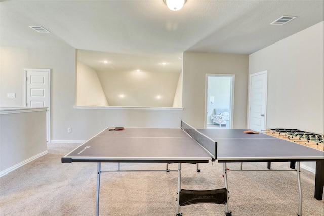 playroom featuring light carpet and vaulted ceiling