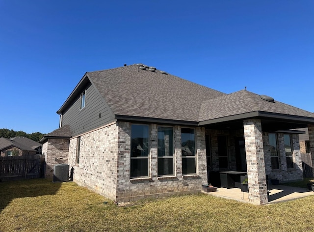 back of property featuring a lawn, central AC unit, and a patio