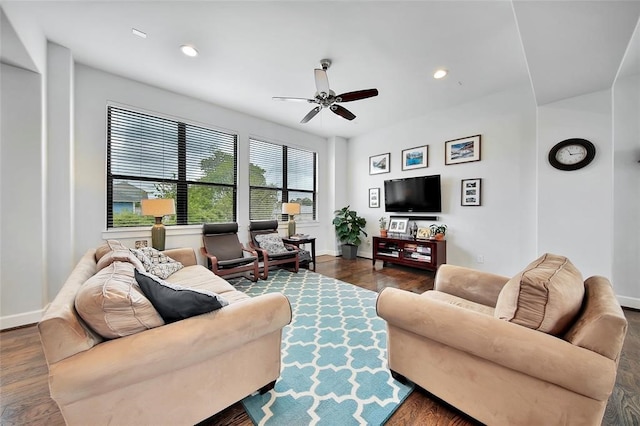 living room featuring dark wood-type flooring and ceiling fan