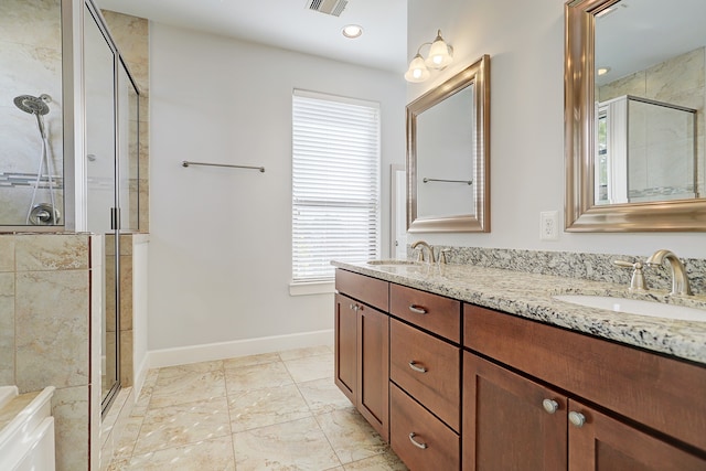 bathroom featuring vanity and a shower with shower door