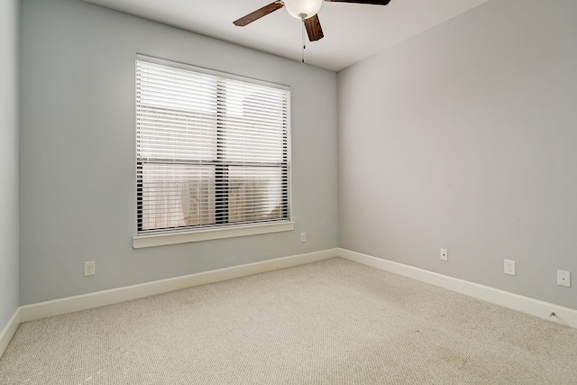 spare room featuring carpet floors and ceiling fan