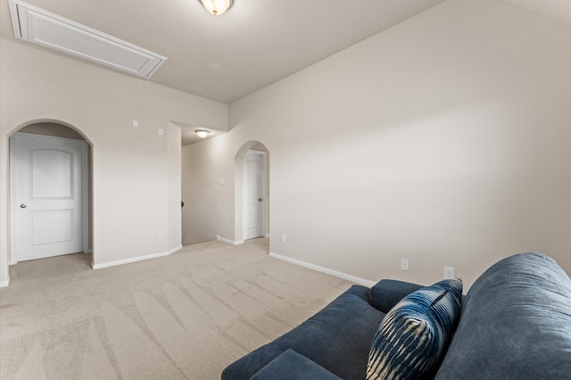 living room with light carpet and vaulted ceiling