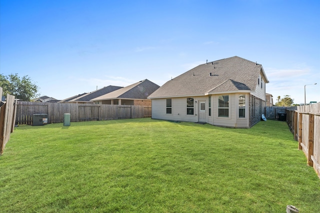 back of house featuring a lawn