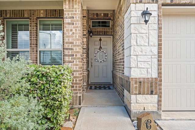 view of exterior entry featuring a garage