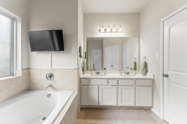 bathroom featuring vanity, tiled bath, and tile patterned flooring