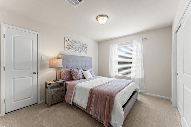 bedroom featuring a closet and light colored carpet