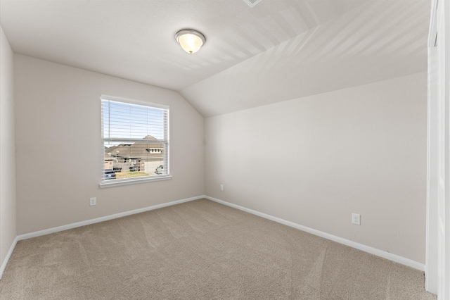 additional living space featuring lofted ceiling and carpet floors