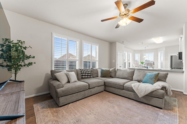 living room featuring hardwood / wood-style floors and ceiling fan