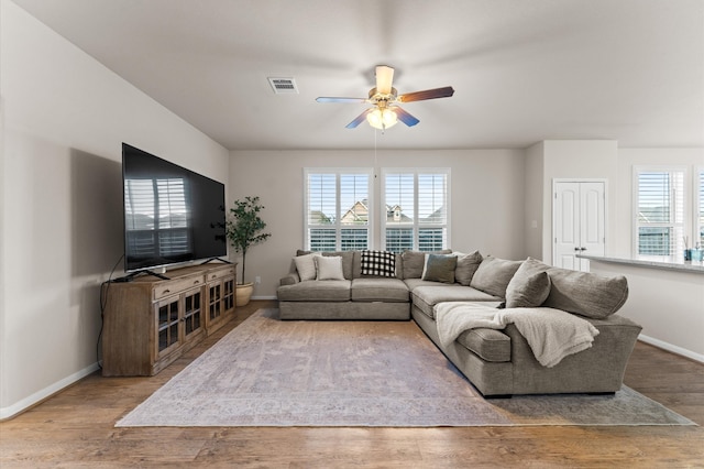 living room with hardwood / wood-style floors and ceiling fan