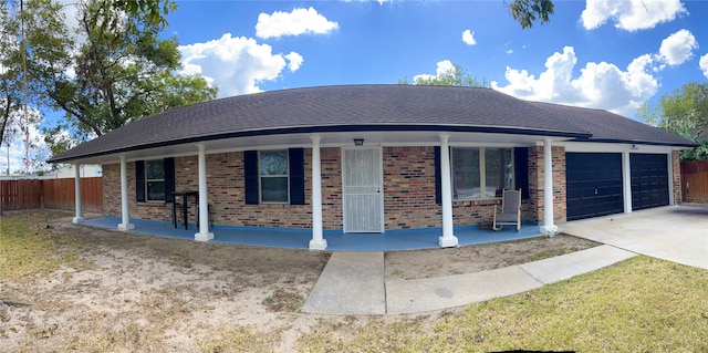 ranch-style home with covered porch and a garage