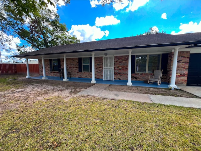 ranch-style house with a front yard and a porch