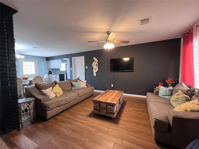 living room with light hardwood / wood-style flooring and ceiling fan