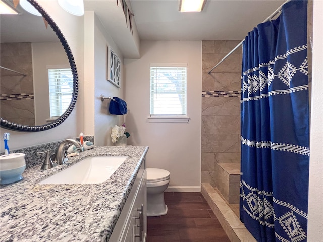 bathroom featuring vanity, toilet, wood-type flooring, and walk in shower