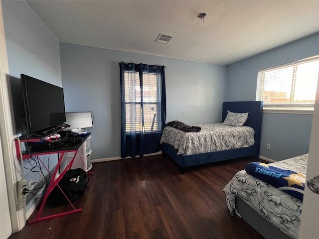 bedroom with dark hardwood / wood-style flooring