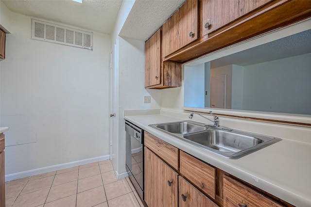 kitchen featuring sink, light tile patterned floors, and dishwasher