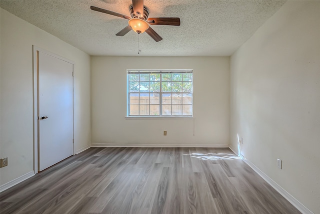 spare room featuring hardwood / wood-style floors, a textured ceiling, and ceiling fan