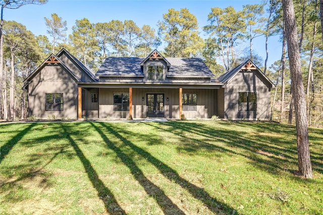 rear view of property featuring french doors and a yard