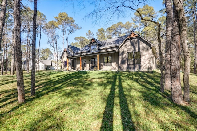 back of house with a porch and a lawn