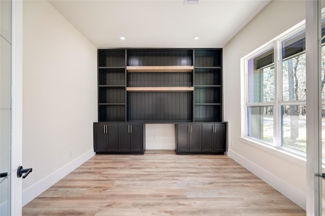 unfurnished office featuring a healthy amount of sunlight and light hardwood / wood-style flooring