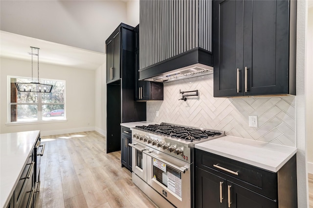 kitchen with double oven range, backsplash, hanging light fixtures, light hardwood / wood-style flooring, and a notable chandelier