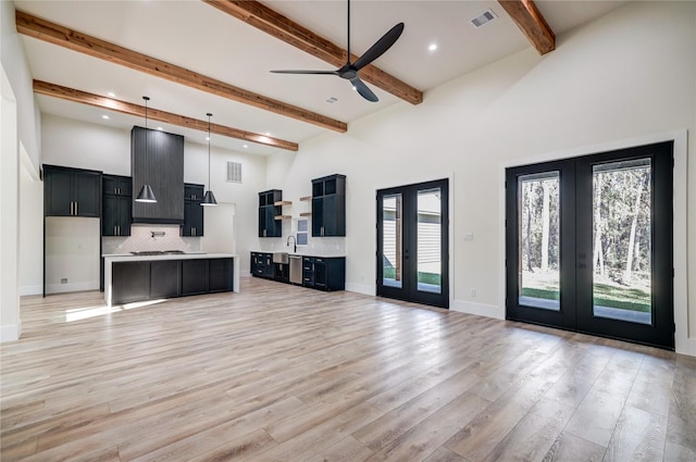 living room featuring beamed ceiling, ceiling fan, light wood-type flooring, and french doors