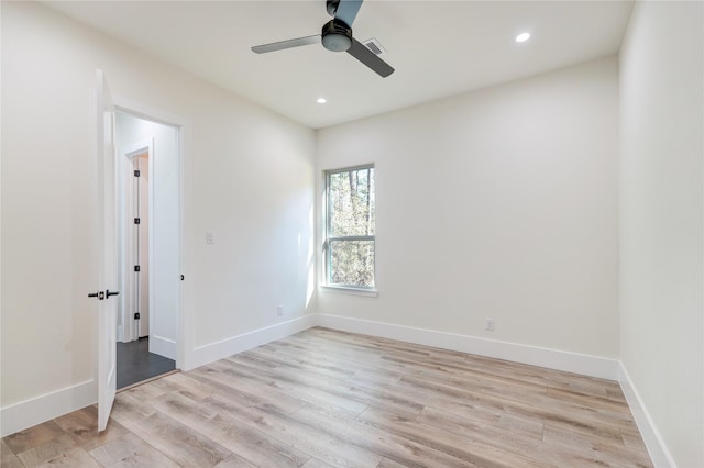 spare room with light hardwood / wood-style flooring and ceiling fan