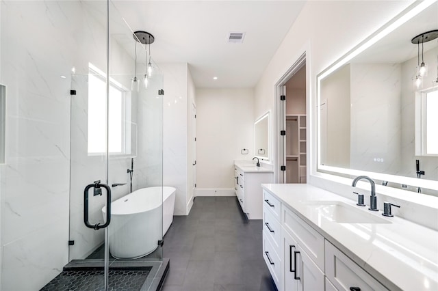 bathroom featuring vanity and separate shower and tub