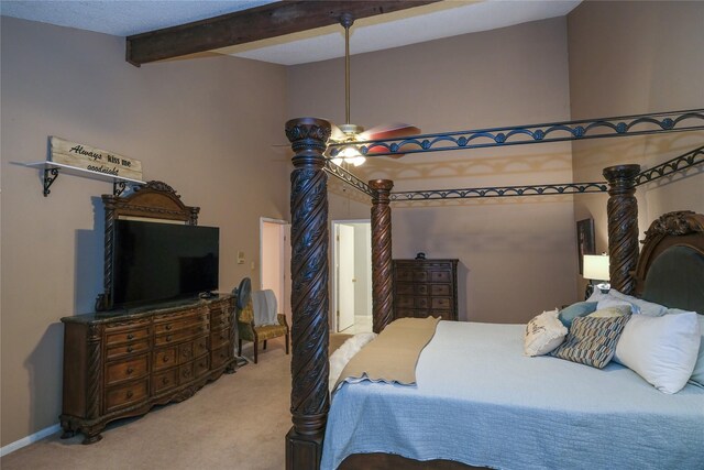 carpeted bedroom featuring beam ceiling and ceiling fan