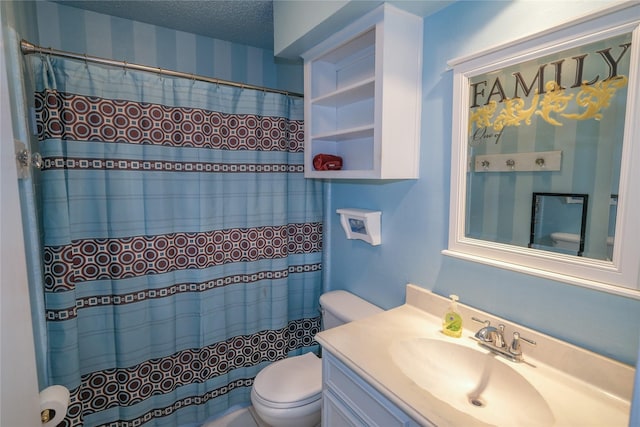 bathroom featuring a shower with shower curtain, vanity, toilet, and a textured ceiling