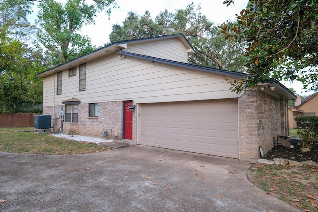 view of property exterior with cooling unit and a garage