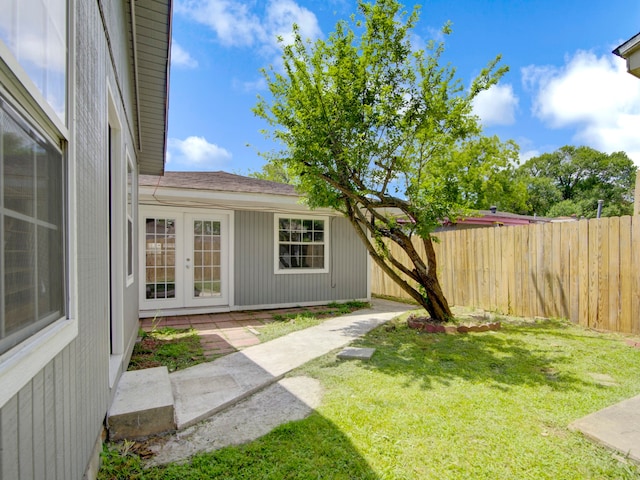 view of yard with french doors and a patio