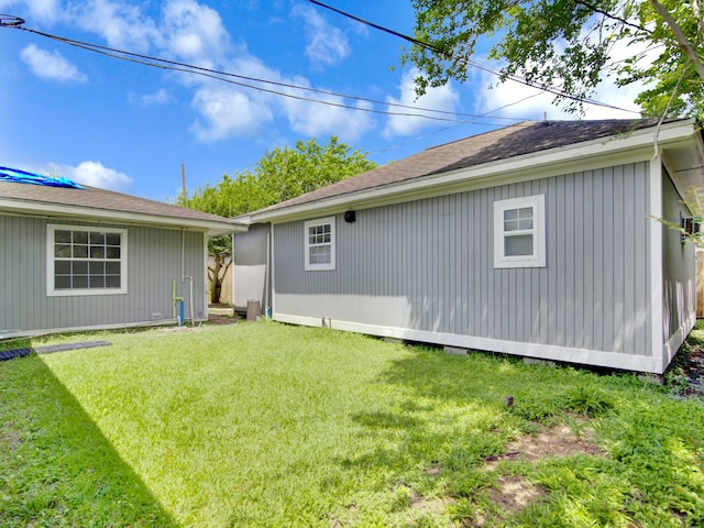 back of property featuring a lawn