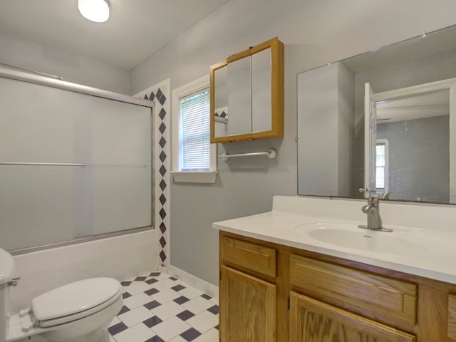 full bathroom with vanity, toilet, and combined bath / shower with glass door