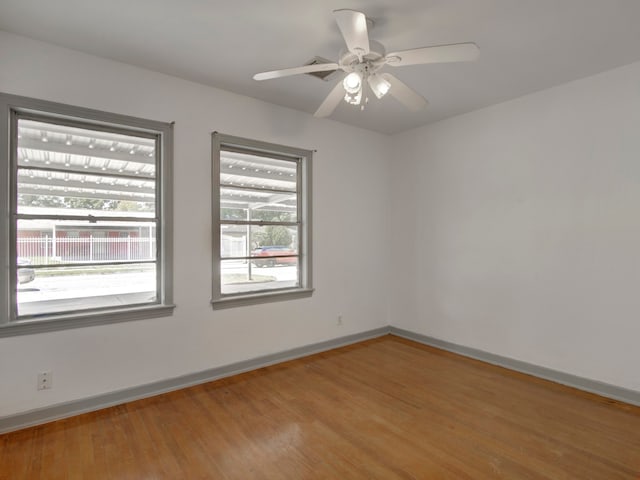 unfurnished room with hardwood / wood-style floors and ceiling fan