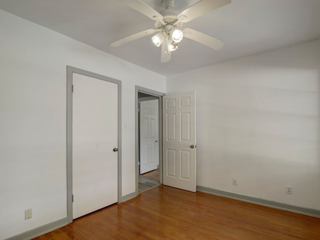 unfurnished bedroom with wood-type flooring and ceiling fan