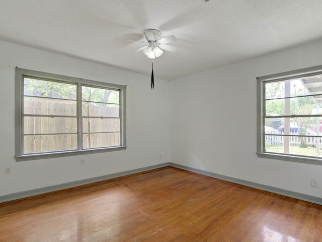 spare room with light hardwood / wood-style floors and ceiling fan