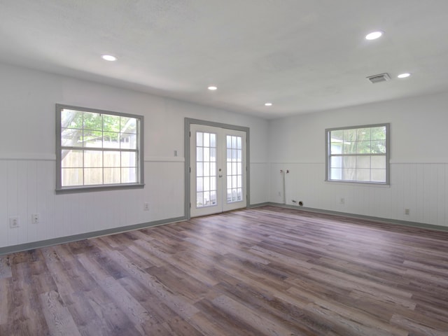 spare room with french doors, hardwood / wood-style flooring, and plenty of natural light