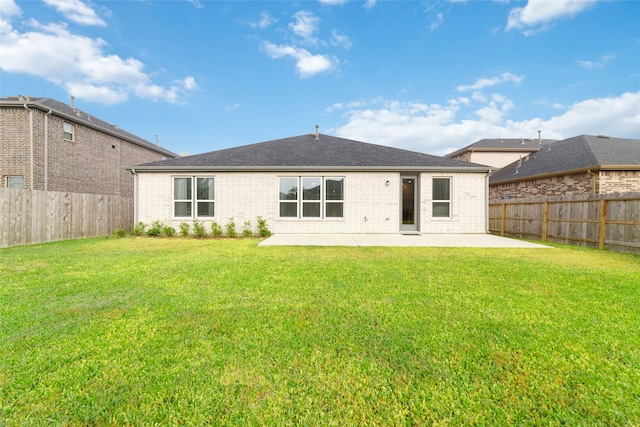 back of house with a yard and a patio