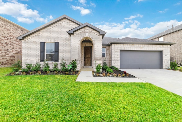 view of front of property with a front yard and a garage