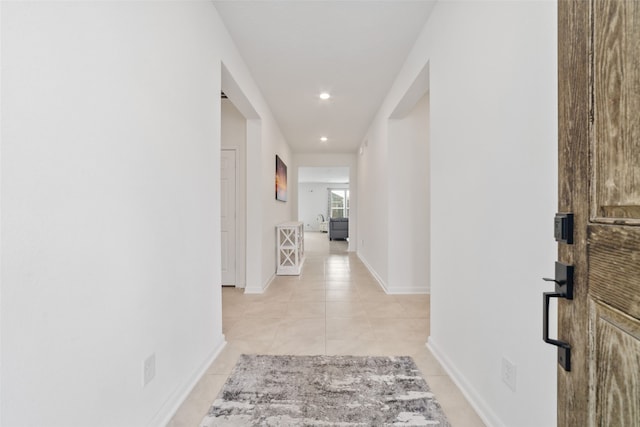 hall featuring light tile patterned flooring