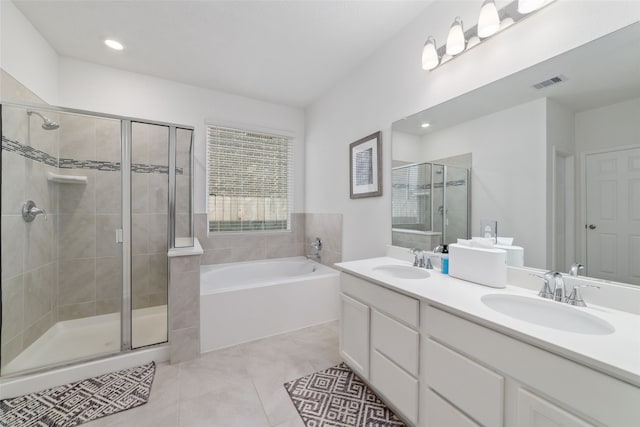 bathroom featuring vanity, plus walk in shower, and tile patterned floors