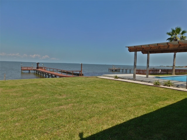 dock area with a patio, a yard, and a water view