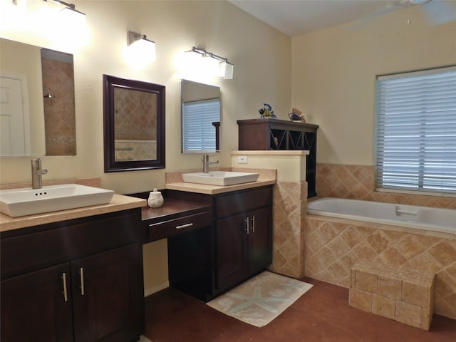 bathroom featuring vanity, a relaxing tiled tub, and tile patterned flooring