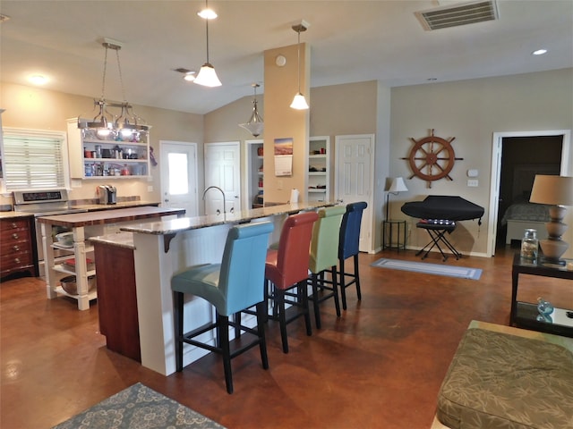 kitchen with plenty of natural light, light stone countertops, decorative light fixtures, and a kitchen bar