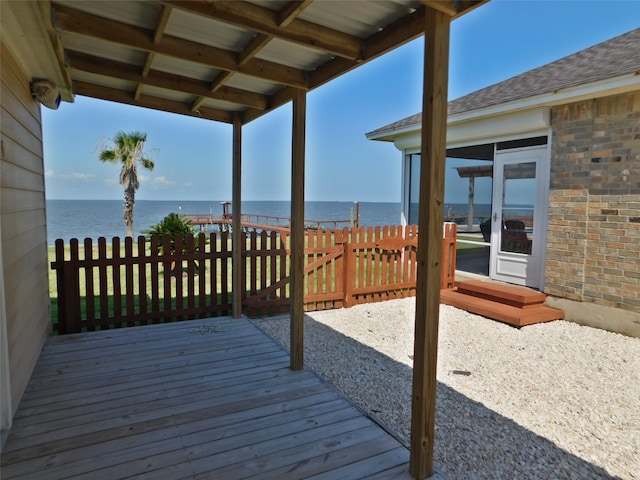 wooden terrace featuring a water view